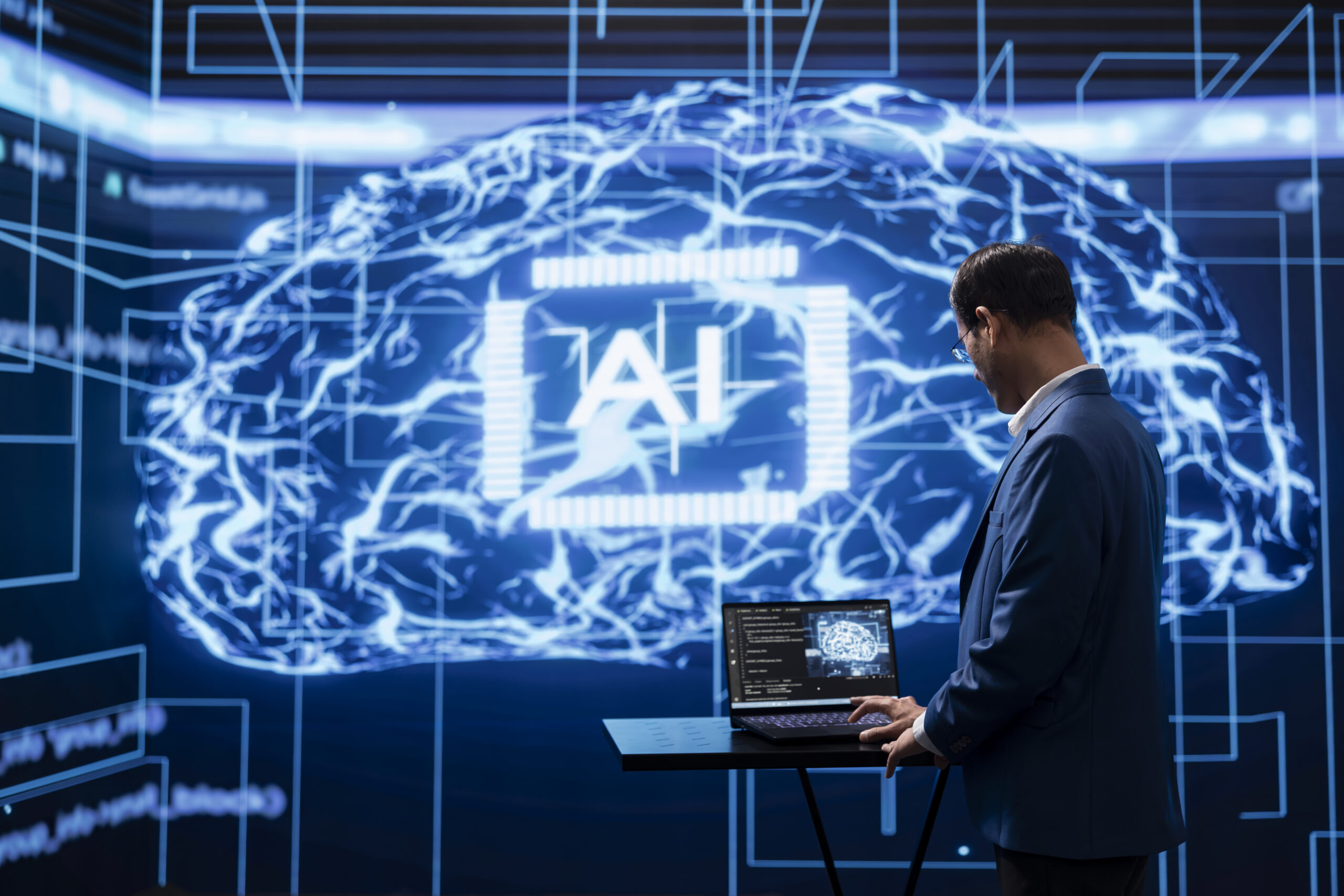 Programmer running ai cognitive computing tech on laptop to simulate human thought processes in computerized model. Indian man typing code on notebook, using self learning algorithms to do data mining