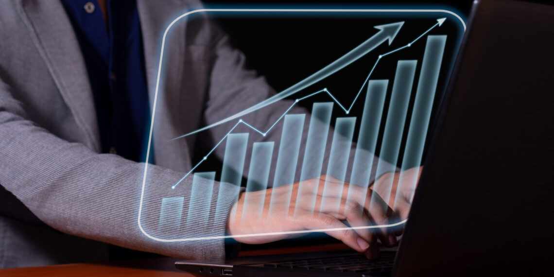 Entrepreneur analyzes economic and financial growth. Investment chart and economic trends.